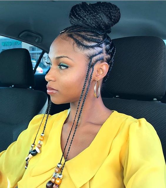 Fulani braided buns with tendrils and beads at the temple